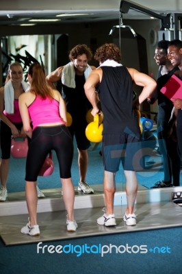 Fitness Trainer Giving Out Instructions To People Stock Photo