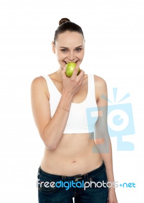 Fitness Woman Eating Green Apple Stock Photo