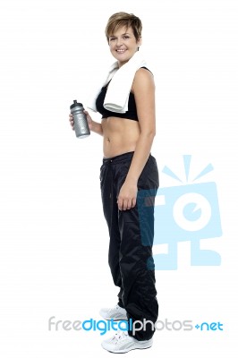 Fitness Woman Posing After Workout. Holding Water Bottle Stock Photo