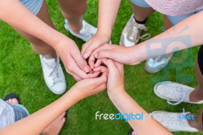 Five Arms With Hands Of Children Entangled Stock Photo