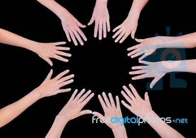 Five Children Hands Joining In Circle Above Black Background Stock Photo