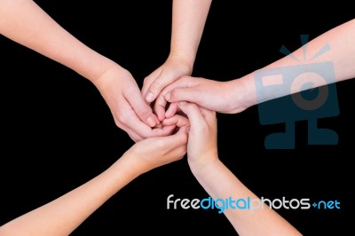 Five Teenage Arms With Hands Entangled Isolated On Black Backgro… Stock Photo