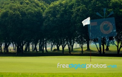 Flag On Grass Field In Golf Course Stock Photo