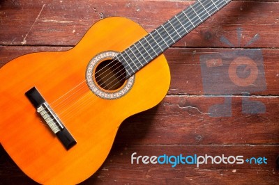 Flamenco Guitar On Wood Background Illuminated By Natural Daylight Stock Photo