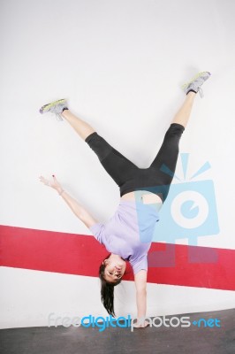 Flexible Girl Standing On One Hand Stock Photo