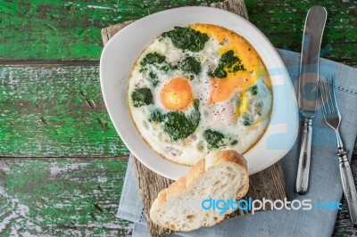 Florentine Eggs With Pureed Spinach On The Wooden Table Horizontal Stock Photo