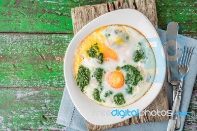 Florentine Eggs With Pureed Spinach On The Wooden Table Top View… Stock Photo