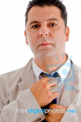 Flourishing Businessman Tying His Tie Stock Photo