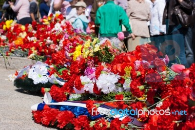 Flowers Near The Monument On Victory Day Stock Photo