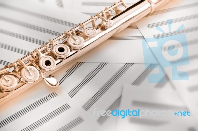 Flute On Sheet Music Stock Photo