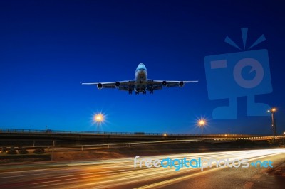 Flying Passenger Jet Plane Above Traffic Light On Express Ways U… Stock Photo