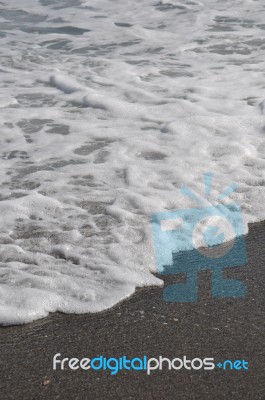 Foam On Sand Stock Photo