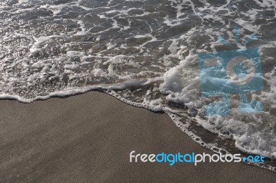 Foam On Sand Stock Photo