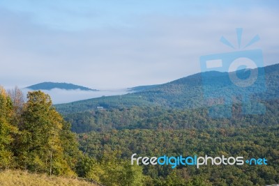 Fog Partially Covering Hills Stock Photo