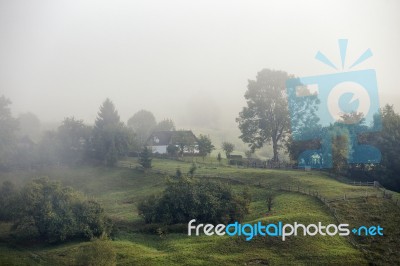 Foggy Morning In A Village On The Hills Stock Photo