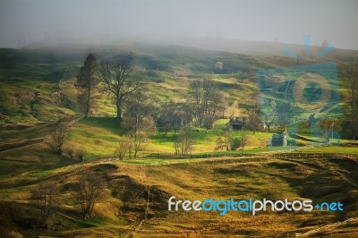 Foggy Spring Morning In Mountain Village. Fields And Hills Stock Photo