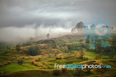 Foggy Spring Morning In Mountain Village. Fields And Hills Stock Photo