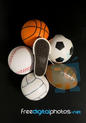 Foot Print On Shoe Among Balls In Black Background Stock Photo