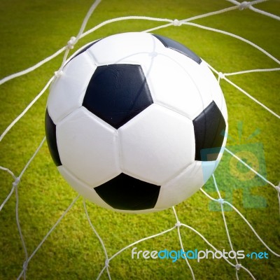 Football Ball In Goal Net Stock Photo