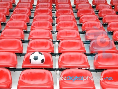 Football On Stadium Chairs Stock Photo