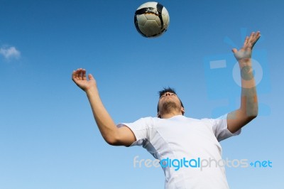 Football Player Striking The Ball At The Stadium Stock Photo