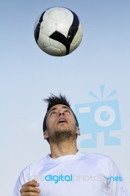 Football Player Striking The Ball At The Stadium Stock Photo