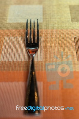 Fork On The Colorful Napery Stock Photo