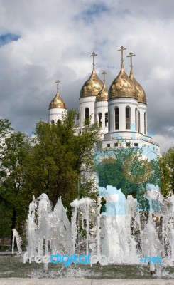 Fountain Near Church With Cloudy Sky Stock Photo