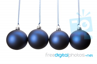 Four Blue Christmas Balls Hanging In Row Stock Photo