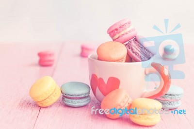 French Macarons In Cup On Pink Wooden Background.toned Image Stock Photo