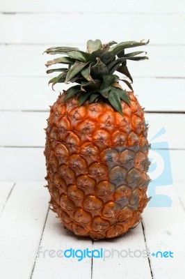 Fresh Azores Pineapple Fruit Isolated On A White Wooden Background Stock Photo