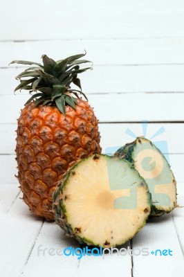 Fresh Azores Pineapple Fruit Isolated On A White Wooden Background Stock Photo