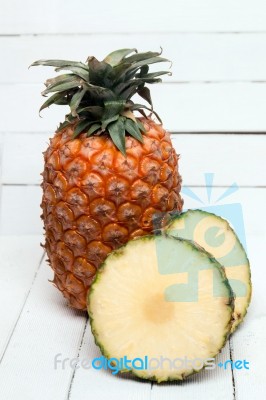 Fresh Azores Pineapple Fruit Isolated On A White Wooden Background Stock Photo