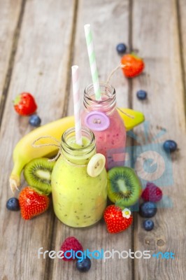 Fresh Blended Fruit Smoothies In Vintage Milk Bottles Stock Photo