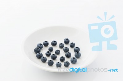 Fresh Blueberries On A White Plate Stock Photo