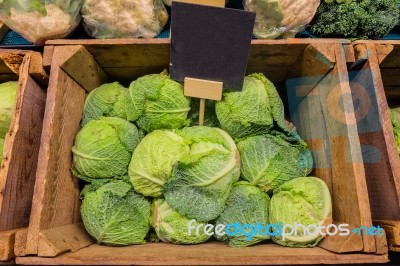 Fresh Cabbage Vegetable In Wooden Box Stall In Greengrocery With Blank Chalkboard Label Stock Photo