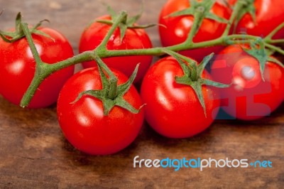 Fresh Cherry Tomatoes On A Cluster Stock Photo