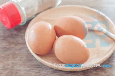 Fresh Eggs On Wooden Plate Stock Photo