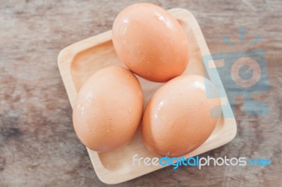 Fresh Eggs On Wooden Plate Stock Photo