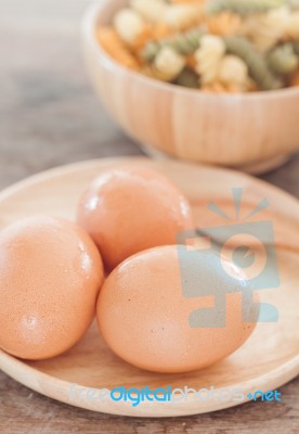 Fresh Eggs On Wooden Plate With Fusili Stock Photo