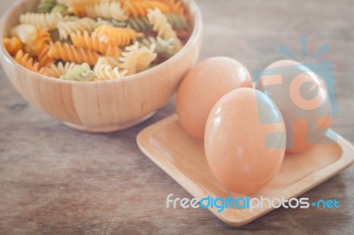 Fresh Eggs On Wooden Plate With Fusili Stock Photo