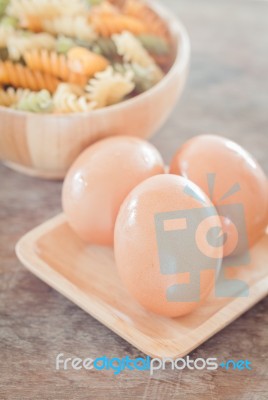 Fresh Eggs On Wooden Plate With Fusili Stock Photo