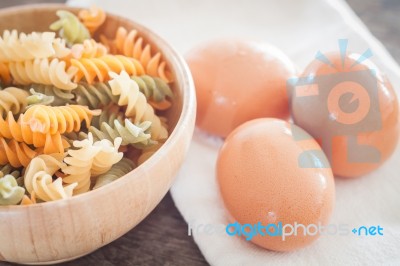 Fresh Eggs On Wooden Plate With Fusili Stock Photo