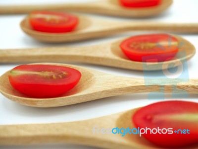 Fresh Grape Or Cherry Tomato With Wooden Spoon On White Backgrou… Stock Photo