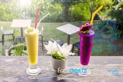 Fresh Jackfruit Juice And Dragon Fruit Juice With Garden Background Stock Photo