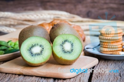 Fresh Kiwi With Cracker On Wood Table Stock Photo