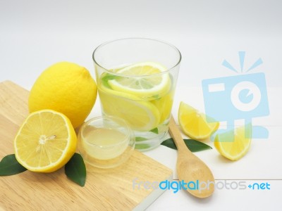 Fresh Lemon In Water, Lemonade And Lemon Slice On White Wood Bac… Stock Photo