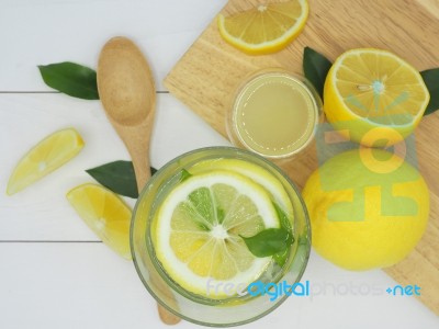 Fresh Lemon In Water, Lemonade And Lemon Slice On White Wood Bac… Stock Photo