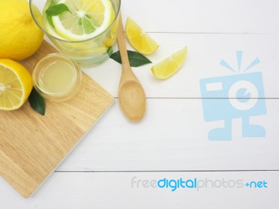 Fresh Lemon In Water, Lemonade And Lemon Slice On White Wood Bac… Stock Photo