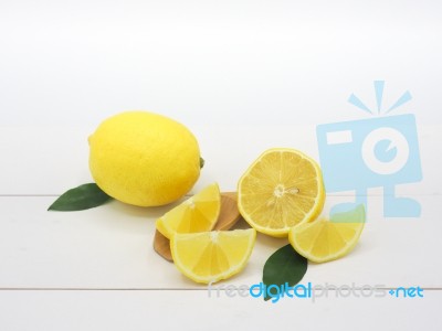 Fresh Lemon Slice On White Wood Background Stock Photo